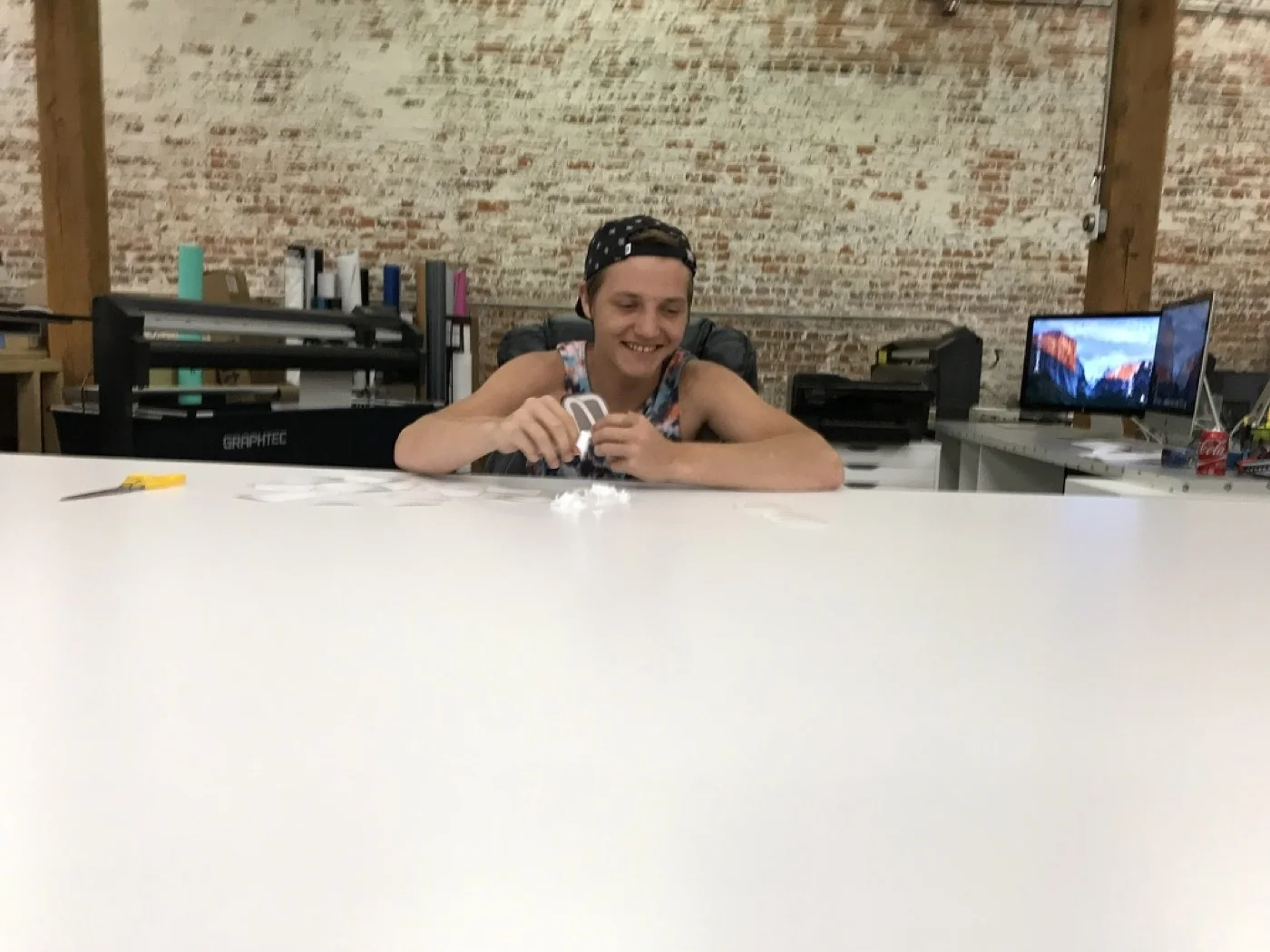 Weeding vinyl at the big table in the warehouse